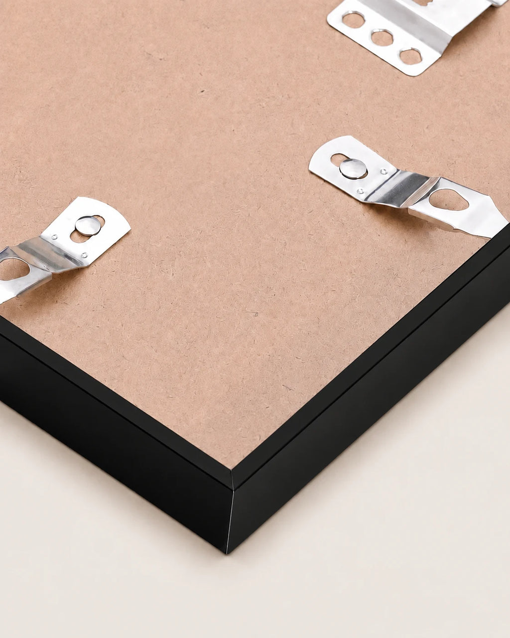 Back of the black metal frame, showing the backing board and the metal hanging clips